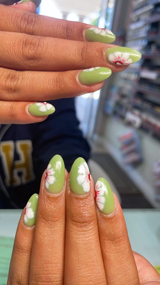 Pistachio green almond nails with hand-painted white hibiscus